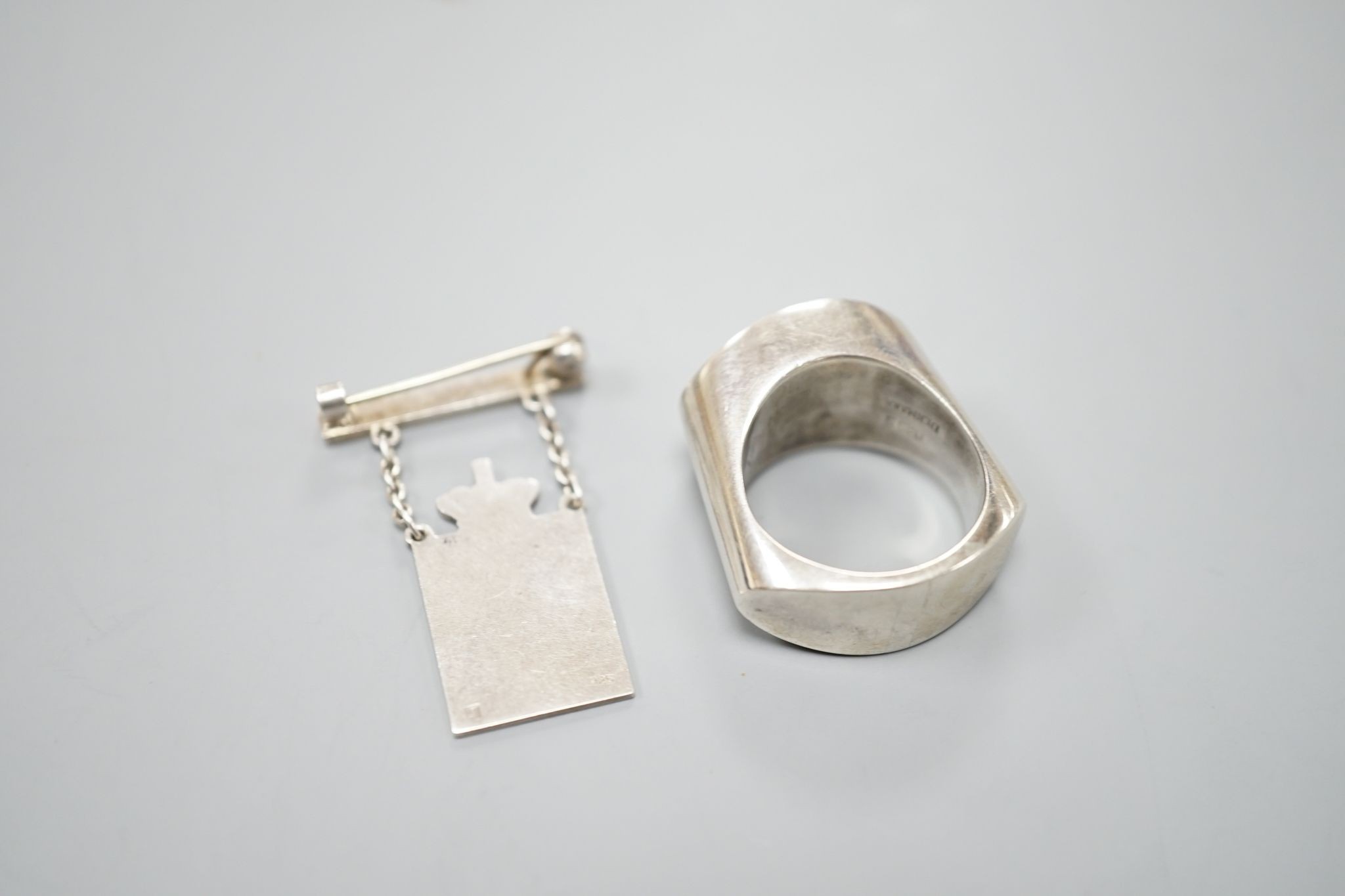 A Georg Jensen sterling ring, no. A11O B, size Q and a Georg Jensen 925 and enamel CX 1870-1940 King Christian drop brooch, 32mm.